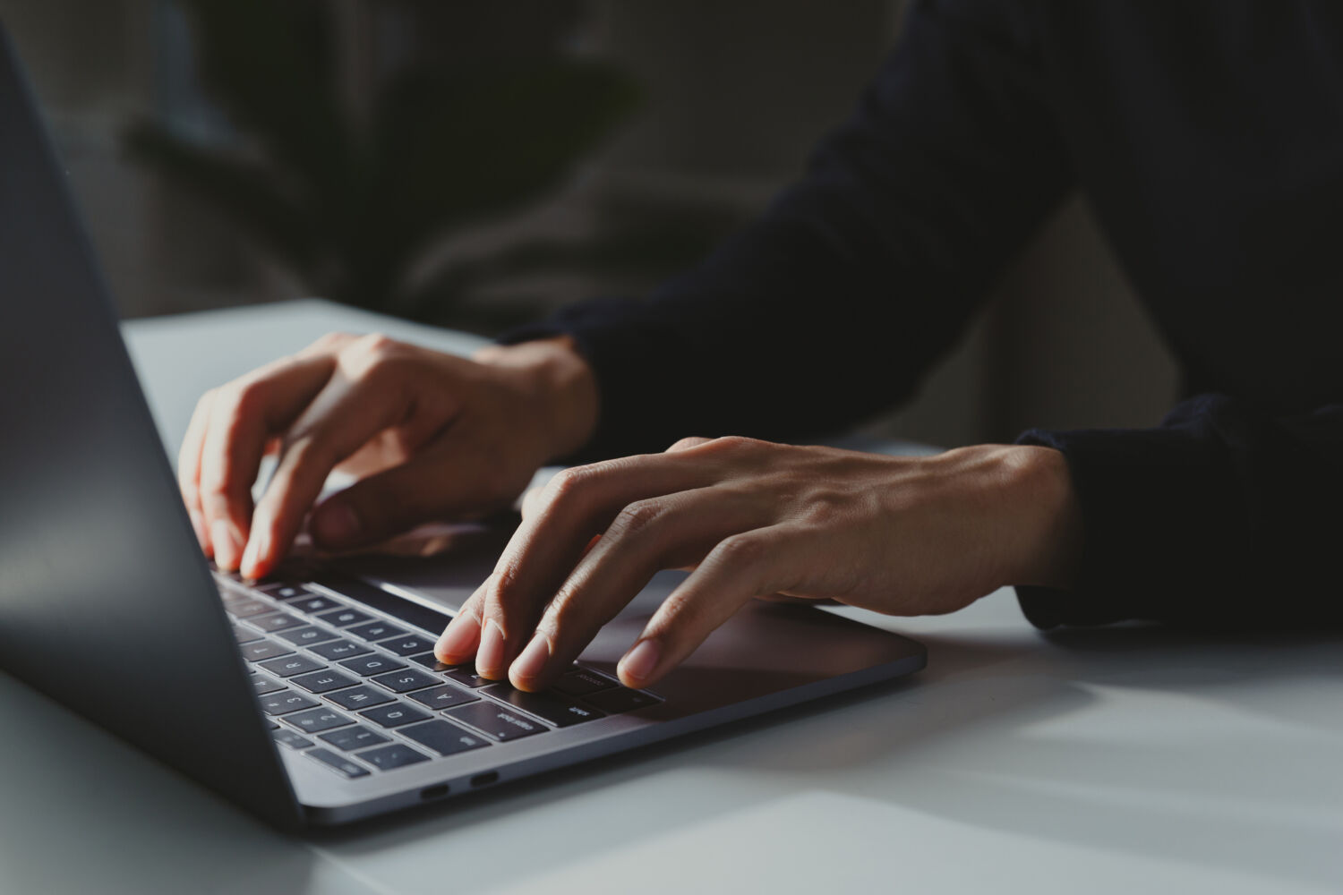 Young businessman working with laptop at home office.