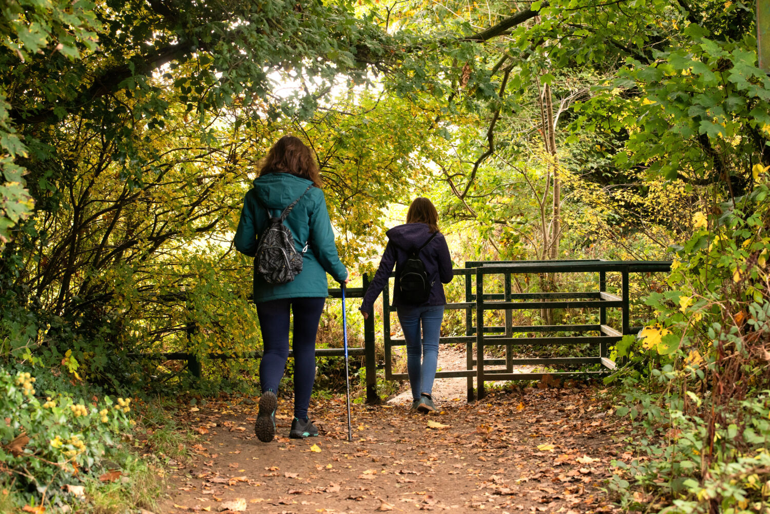 Mother and daughter walking through the kissing gate, in Wickersley, Rotherham.