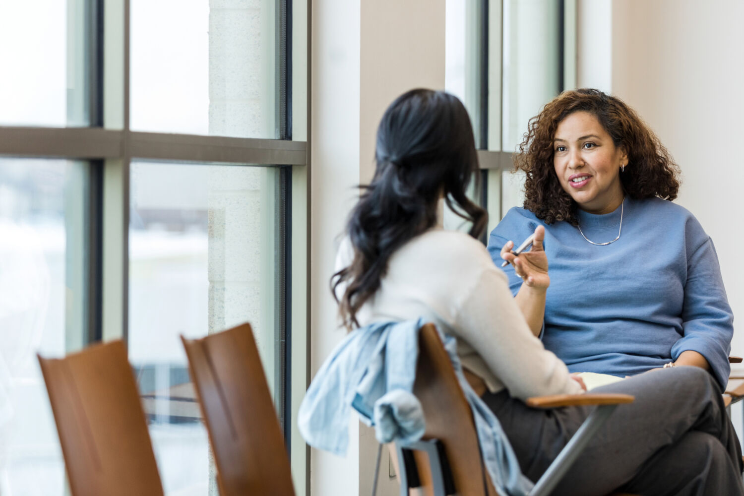 Unrecognizable female client listens as female counselor gives advice